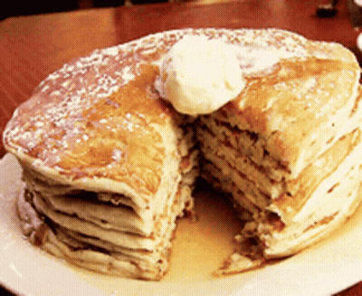 A Stack Of Pancakes With Butter And Syrup On A Plate GIF