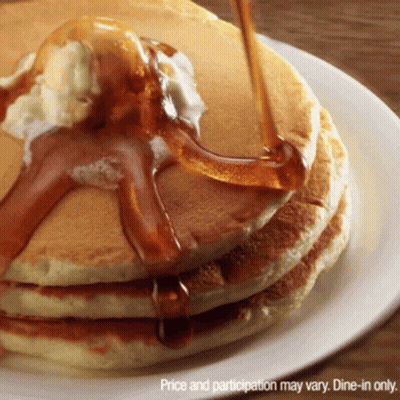 A Stack Of Pancakes With Syrup Being Poured On Top Of Them GIF