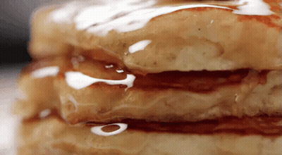 A Stack Of Pancakes With Syrup On Them GIF