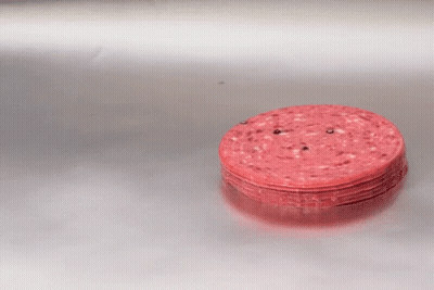 A Stack Of Sliced Sausages On A Silver Surface GIF