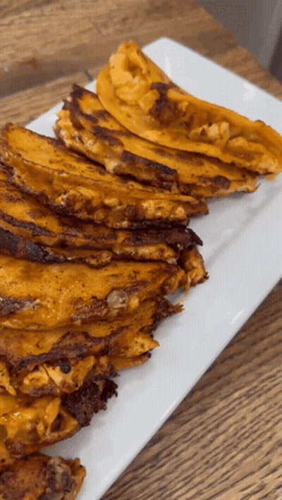 A Stack Of Tacos On A White Plate On A Table GIF