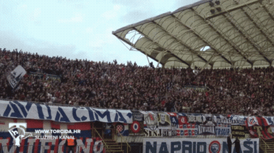 A Stadium Full Of People With A Banner That Says Avjacma GIF