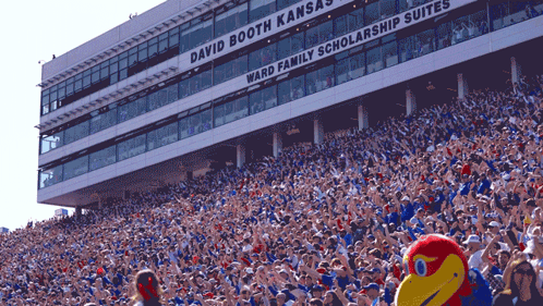 A Stadium Full Of People With The Words David Booth Kansas Ward Family Scholarship Suites GIF