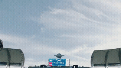A Stadium With A Sign That Says " Happy Holidays " GIF
