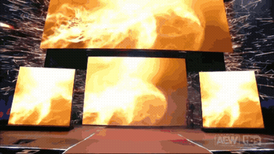 A Stage With A Large Screen That Says Aew On The Bottom GIF