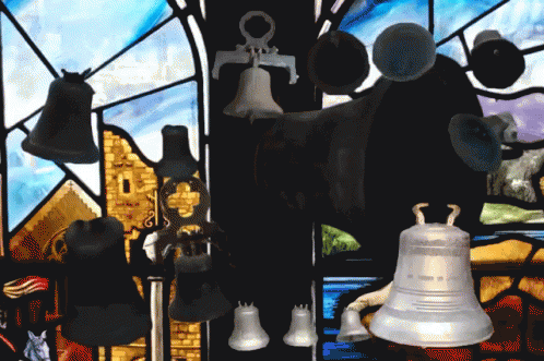 A Stained Glass Window With A Bunch Of Bells Hanging From It GIF