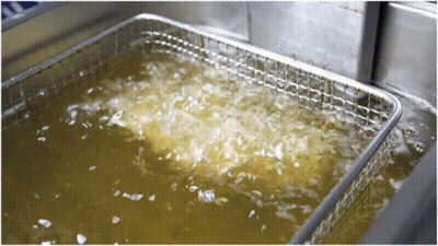 A Stainless Steel Fryer Is Filled With A Yellow Liquid GIF