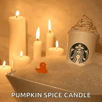 A Starbucks Cup Is In A Bathtub With Candles GIF