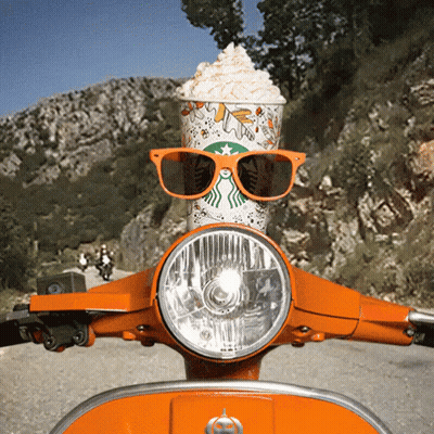 A Starbucks Cup With Whipped Cream Sits On A Scooter GIF