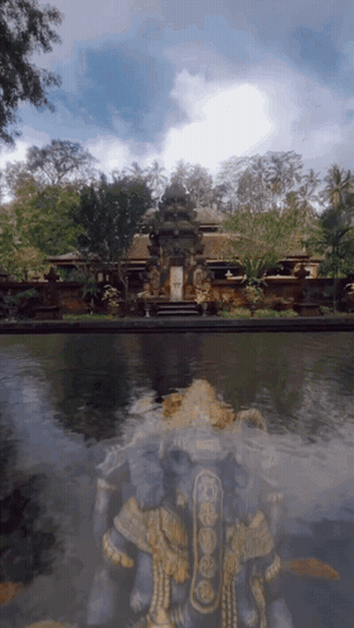 A Statue In Front Of A Building With The Letter W On It GIF