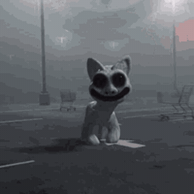 A Statue Of A Cat With Big Eyes Is Sitting On A Box In A Parking Lot . GIF