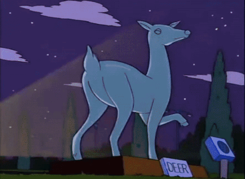 A Statue Of A Deer With A Sign That Says Deer In Front Of It GIF