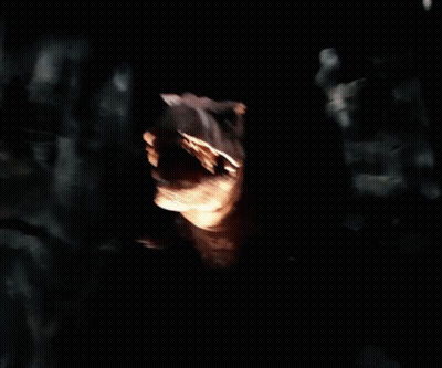 A Statue Of A Dinosaur With Its Mouth Wide Open GIF