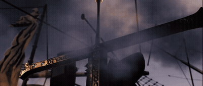 A Statue Of A Dragon Is Behind A Very Tall Pole That Says ' X ' GIF