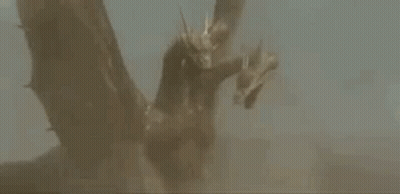 A Statue Of A Dragon With Three Heads And Wings Is Flying In The Air . GIF