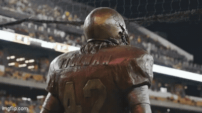 A Statue Of A Football Player Wearing The Number 12 GIF