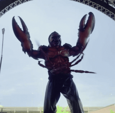A Statue Of A Man Dressed As A Lobster With Huge Claws GIF