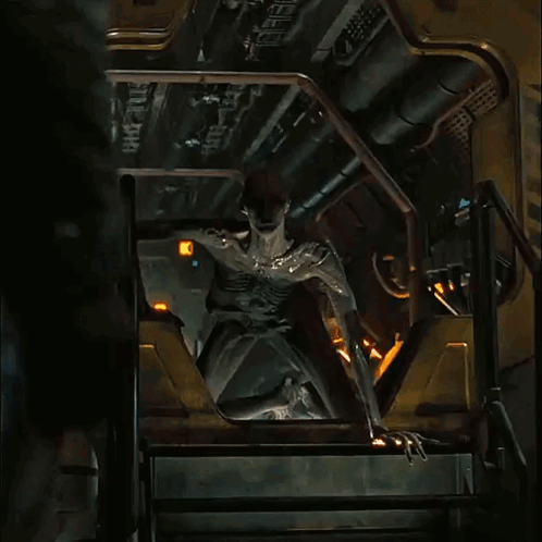A Statue Of A Man Is Sitting On A Set Of Stairs With The Number 8 On It GIF