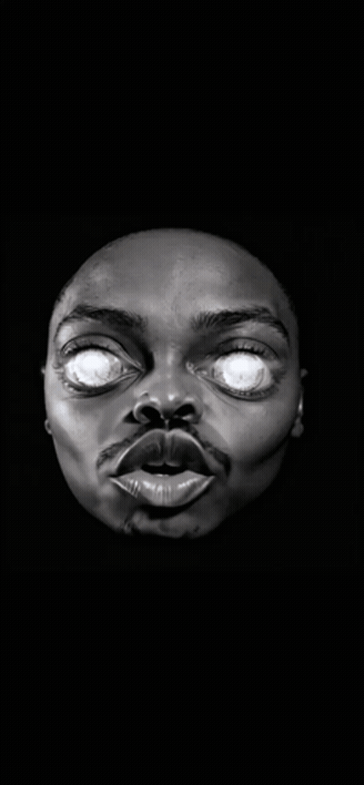 A Statue Of A Man 'S Face With Glowing Eyes In The Dark GIF