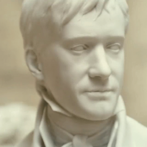 A Statue Of A Man 'S Face With His Eyes Closed GIF