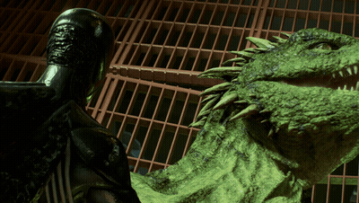 A Statue Of A Man Standing Next To A Large Green Monster GIF