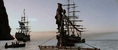 A Statue Of A Man Standing On Top Of A Ship In The Middle Of A Body Of Water GIF