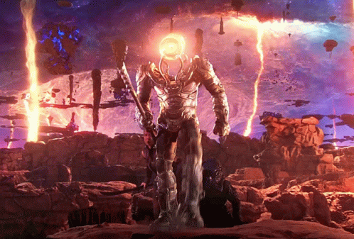 a statue of a man with a glowing head stands in front of a purple sky