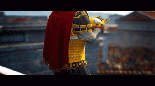 A Statue Of A Man With A Red Cape And Gold Armor With The Number 2 On It GIF