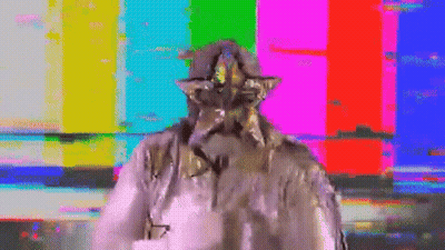 A Statue Of A Man With A Star On His Head Is Standing In Front Of A Colorful Background . GIF