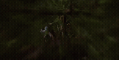 A Statue Of A Man With A Sword In His Hand Is Standing Next To A Tree GIF