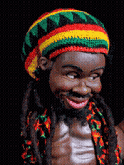 A Statue Of A Man With Dreadlocks And A Colorful Hat GIF
