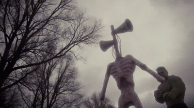 A Statue Of A Monster With A Megaphone In Its Head GIF