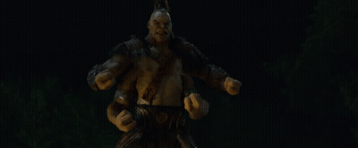 A Statue Of A Monster With His Mouth Open And Arms Outstretched In The Dark GIF