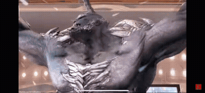 A Statue Of A Monster With Horns And Wings Is Standing In Front Of A Screen . GIF