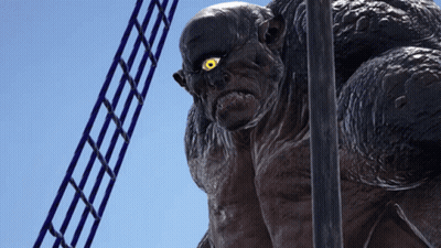 A Statue Of A Monster With Yellow Eyes Is Standing Next To A Ladder GIF