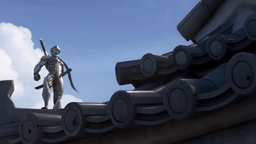 A Statue Of A Robot Holding A Sword Stands On Top Of A Roof GIF