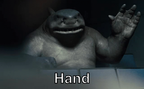A Statue Of A Shark With The Word Hand Written Below It GIF