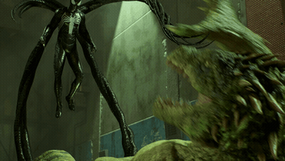 A Statue Of A Spider Man Standing Next To A Large Green Monster GIF