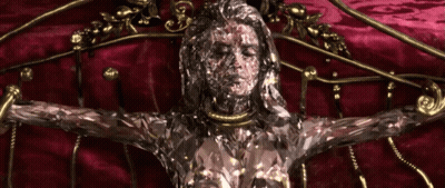 A Statue Of A Woman With A Necklace Around Her Neck GIF