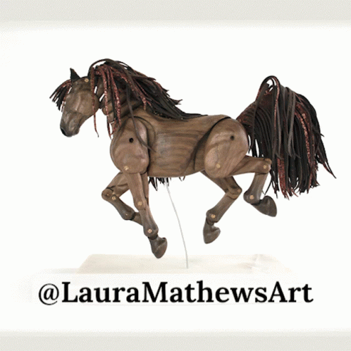 A Statue Of A Wooden Horse With The Name Laura Mathews Art On The Bottom GIF