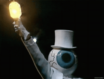 A Statue Of An Eye Wearing A Top Hat Holds A Light GIF