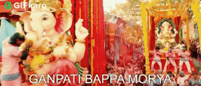 A Statue Of Ganpati Is Being Paraded Through A Crowd Of People At A Festival In India . GIF
