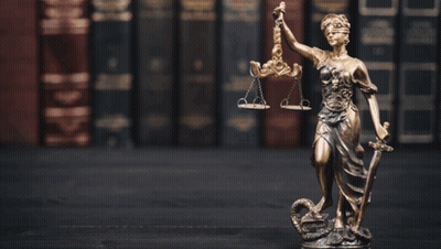 A Statue Of Lady Justice Holding Scales Of Justice And A Sword GIF