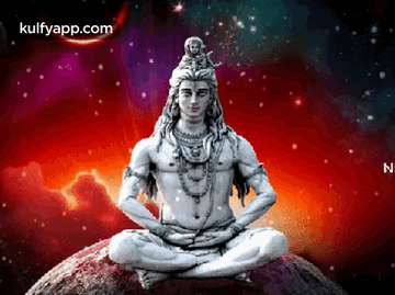 A Statue Of Lord Shiva Is Sitting On Top Of A Rock In A Lotus Position . GIF