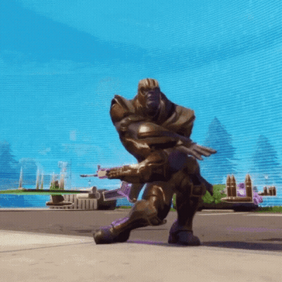 A Statue Of Thanos Is Kneeling Down With A Gun GIF