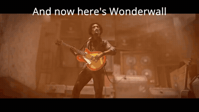 A Statue With The Words And Now Here 'S Wonderwall Behind It GIF