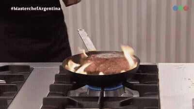 A Steak Is Being Cooked In A Frying Pan On A Stove With The Hashtag Masterchefargentina GIF