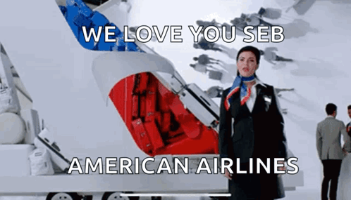 A Stewardess Is Standing In Front Of An American Airlines Logo GIF
