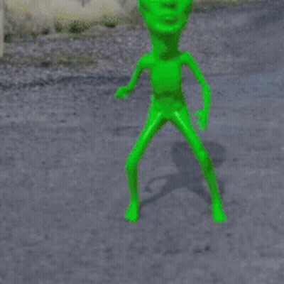 A Stop Sign With A Green Alien In Front Of It GIF