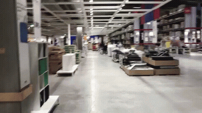 A Store Aisle With A Sign That Says Exit On It GIF